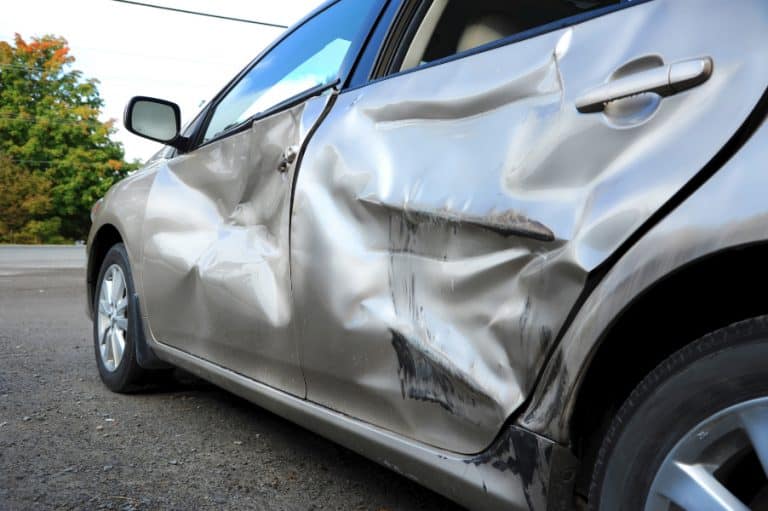 a dented car at cash for cars removal auckland